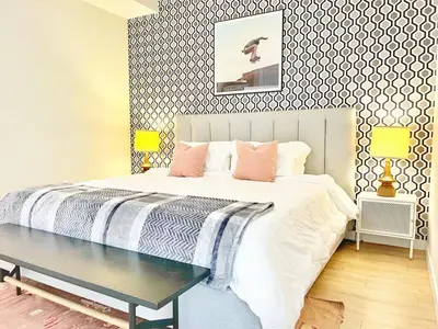 a bedroom with a bed and a table in it at Sunset Stay in Downtown San Diego in San Diego