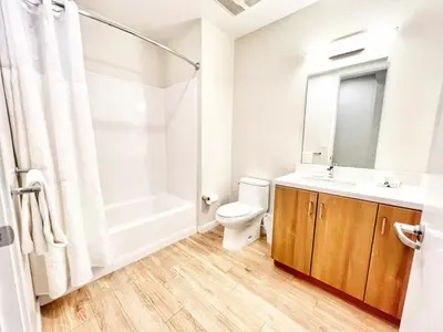 a bathroom with a toilet and a sink and a shower at Sunset Stay in Downtown San Diego in San Diego