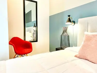 a bedroom with a red chair and a mirror at Beautiful One Bedroom Apartment With View of City in San Diego