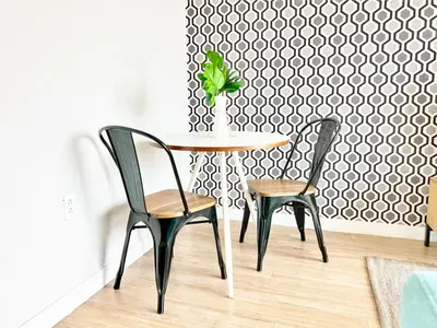 a table with two chairs and a table with a plant on it at Beautiful One Bedroom Apartment With View of City in San Diego