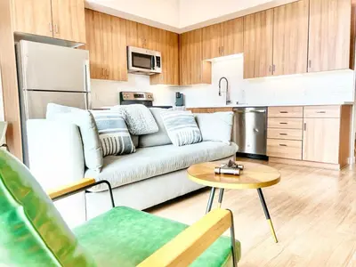 a living room with a couch and a kitchen at City View Apartment in Downtown! in San Diego