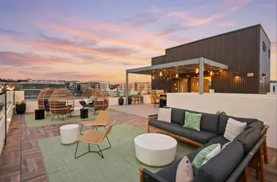 a rooftop patio with couches and tables on a building at San Diego Skyline - Downtown Apartment in San Diego