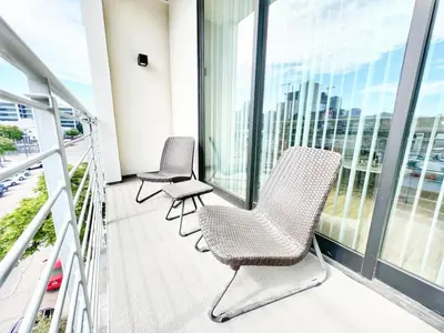 a balcony with chairs and a view of the city at The Executive Getaway in San Diego