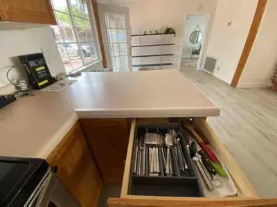 a kitchen with a counter top with a drawer at The most breathtaking Lake and Mountain View in Fallbrook