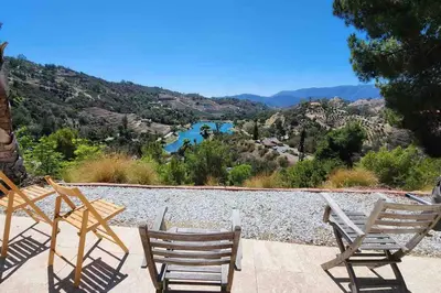 a group of chairs sitting on a patio with a view at The most breathtaking Lake and Mountain View in Fallbrook