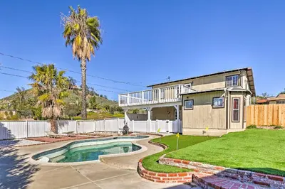 a house with a swimming pool and a palm tree at Mtn-View Home Less Than 1 Mi to Lake Elsinore! in Lake Elsinore