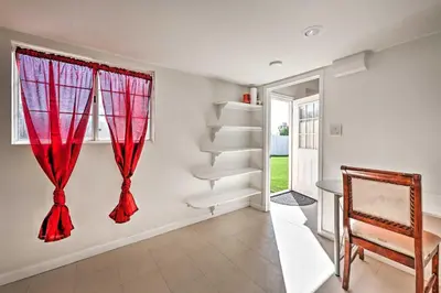a room with a red curtain and a staircase at Mtn-View Home Less Than 1 Mi to Lake Elsinore! in Lake Elsinore