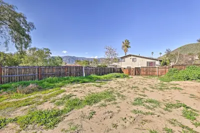 a yard with a fence and a house at Mtn-View Home Less Than 1 Mi to Lake Elsinore! in Lake Elsinore