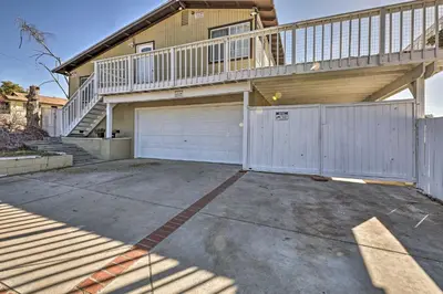 a house with a garage and a balcony at Mtn-View Home Less Than 1 Mi to Lake Elsinore! in Lake Elsinore