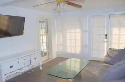 a living room with a tv and a couch and a table at Mountain View Studio in Hemet