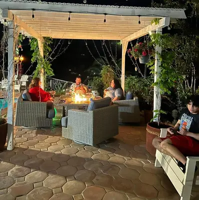 a group of people sitting around a fire in a patio at Mountain View Studio in Hemet