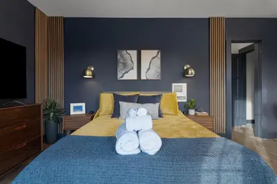 a bedroom with a bed with two towels on it at Modern National City Studio in National City