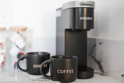two coffee cups sitting on top of a counter at Modern National City Studio in National City