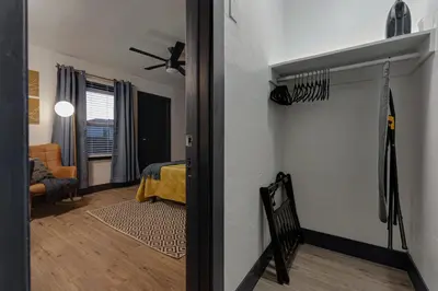 a hallway with a room with a bed and a room with a ceiling at Modern National City Studio in National City