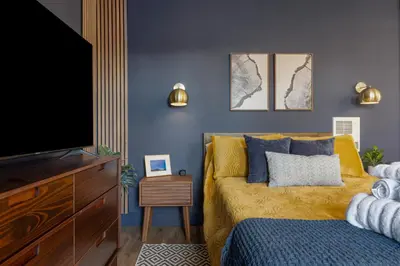 a bedroom with a bed and a flat screen tv at Modern National City Studio in National City