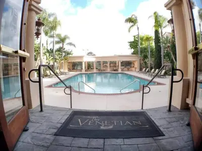 a swimming pool in a building with a sign that reads the veridian at -Vacation-Top corner 2-story one bedroom La Jolla Condo in San Diego