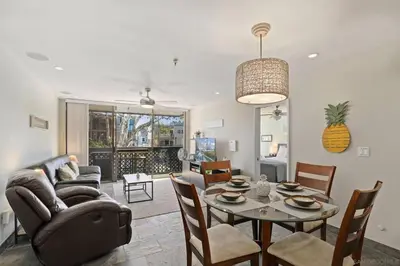 a living room with a couch and a table with chairs at Pineapple Paradise - Mission Beach - Stunning in San Diego