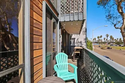 a blue chair sitting on the porch of a building at Pineapple Paradise - Mission Beach - Stunning in San Diego