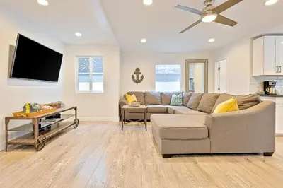 a living room with a couch and a flat screen tv at La Jolla Beach Retreat Compound in San Diego