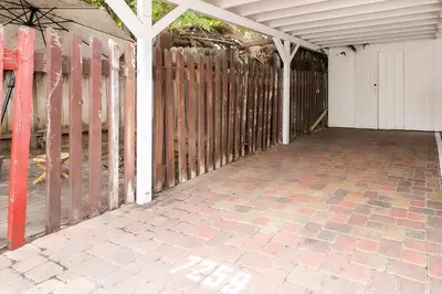 a porch with a fence and a brick patio at La Jolla Beach Retreat Compound in San Diego
