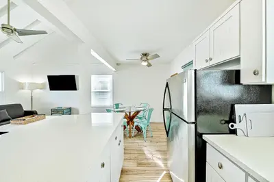 a kitchen with white cabinets and a refrigerator at La Jolla Beach Retreat Compound in San Diego
