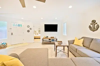 a living room with a couch and a tv at La Jolla Beach Retreat Compound in San Diego