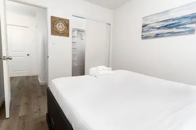 a white bedroom with a large white bed in it at Nautical Point Loma Getaway - 7 mins to airport in San Diego