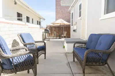 three wicker chairs with blue cushions sitting on a patio at Seaside Point Loma Home with Outdoor Patio in San Diego