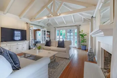 a living room with a couch and a table at Charming La Jolla Shores Cottage in San Diego