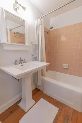 a bathroom with a sink and a bath tub at Charming La Jolla Shores Cottage in San Diego