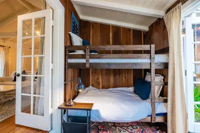 a bedroom with two bunk beds in a room at Charming La Jolla Shores Cottage in San Diego