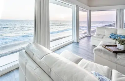 a living room with a white couch and a view of the ocean at CB-2445A - Carlsbad Casa De Los Sueños | Unit A in Carlsbad