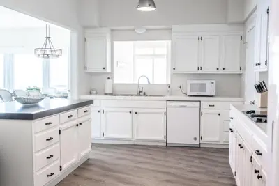 a white kitchen with white cabinets and a sink at CB-2445A - Carlsbad Casa De Los Sueños | Unit A in Carlsbad