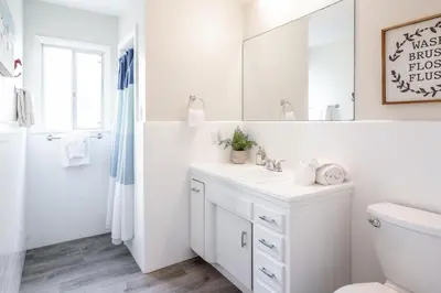 a white bathroom with a sink and a mirror at CB-2445A - Carlsbad Casa De Los Sueños | Unit A in Carlsbad