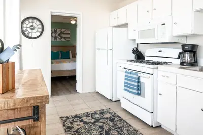 a kitchen with white cabinets and a stove top oven at CB-2445B - Carlsbad Casa De Los Sueños | Unit B in Carlsbad