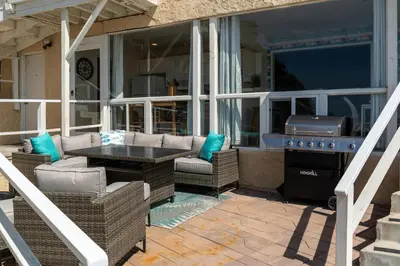 a patio with wicker chairs and a table and a grill at CB-2445B - Carlsbad Casa De Los Sueños | Unit B in Carlsbad