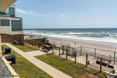 a beach with a building and the ocean at CB-2445B - Carlsbad Casa De Los Sueños | Unit B in Carlsbad