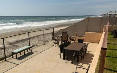 a patio with a table and chairs and the beach at CB-2445B - Carlsbad Casa De Los Sueños | Unit B in Carlsbad