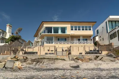a house on the beach with rocks in front of it at CB-2445B - Carlsbad Casa De Los Sueños | Unit B in Carlsbad