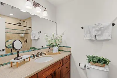 a bathroom with a sink and a mirror at SB-767D - Soothing Solana Oceanfront Condo in Solana Beach