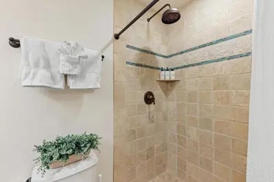 a bathroom with a shower with a toilet and a towel at SB-767D - Soothing Solana Oceanfront Condo in Solana Beach
