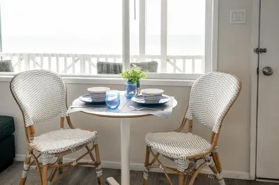 a table and two chairs in a room with a window at CB-2445C - Carlsbad Casa De Los Sueños | Unit C in Carlsbad