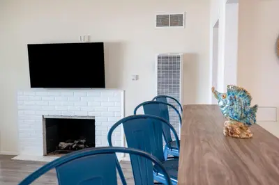a dining room with a table with chairs and a fireplace at CB-2445C - Carlsbad Casa De Los Sueños | Unit C in Carlsbad