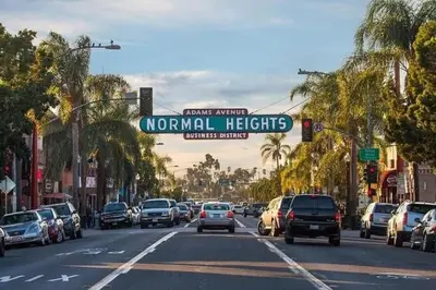 a street sign that reads normal heights on a busy city street at Artfully-styled bungalow in the heart of it all in San Diego