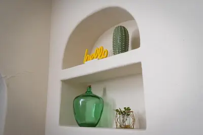 a white shelf with a green vase and a cactus at Artfully-styled bungalow in the heart of it all in San Diego