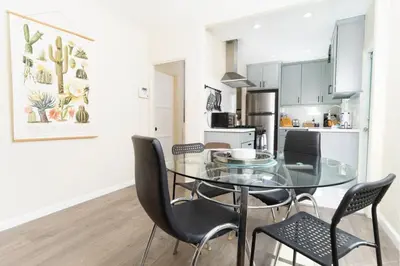 a dining room with a glass table and chairs at Artfully-styled bungalow in the heart of it all in San Diego