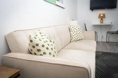 a white couch with pillows on it in a living room at Studio Bungalow in the Heart of Normal Heights in San Diego