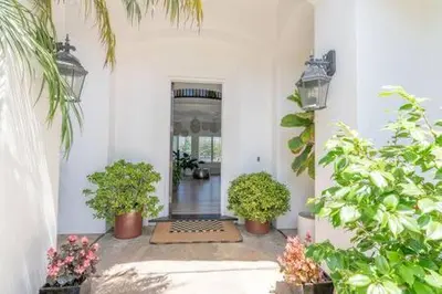 a hallway with potted plants in a building at Carlsbad Dream House with Hot Tub Walk to Beach in Carlsbad