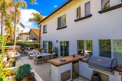 a large white house with a patio with a table at Carlsbad Dream House with Hot Tub Walk to Beach in Carlsbad