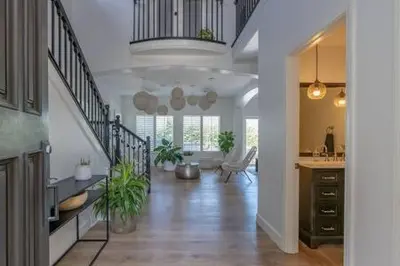 a large living room with a staircase in a house at Carlsbad Dream House with Hot Tub Walk to Beach in Carlsbad